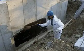 Professional waterproofing the exterior walls of the basement in Kansas City, MO